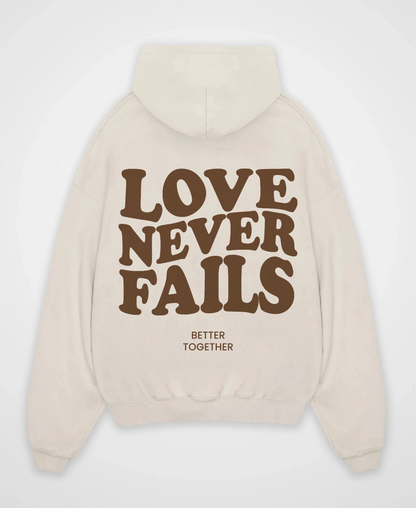 LOVE NEVER FAILS OVERSIZED HOODIE