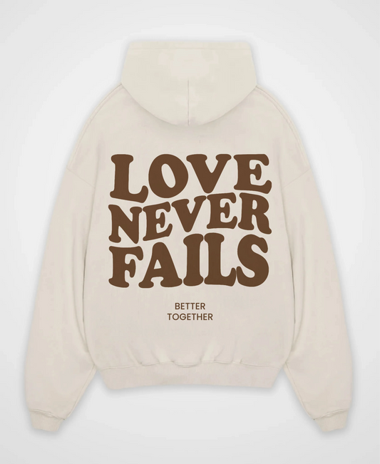 LOVE NEVER FAILS OVERSIZED HOODIE