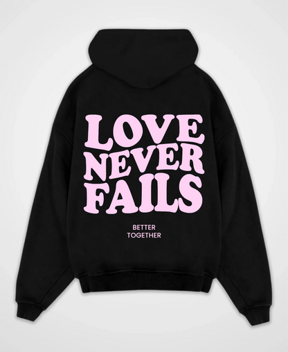 LOVE NEVER FAILS OVERSIZED HOODIE
