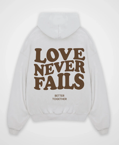 LOVE NEVER FAILS OVERSIZED HOODIE