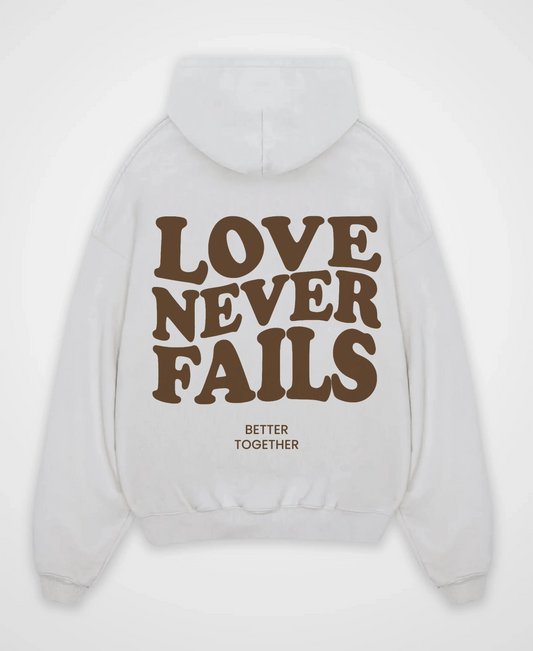 LOVE NEVER FAILS OVERSIZED HOODIE